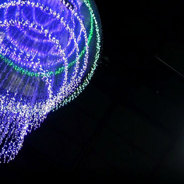 Bottom up view of the with touchscreen controlled effect- and colorchanging chandelier with hundreds of hanging strands at Zürich main train station in the city of Zürich, Swizzerland.