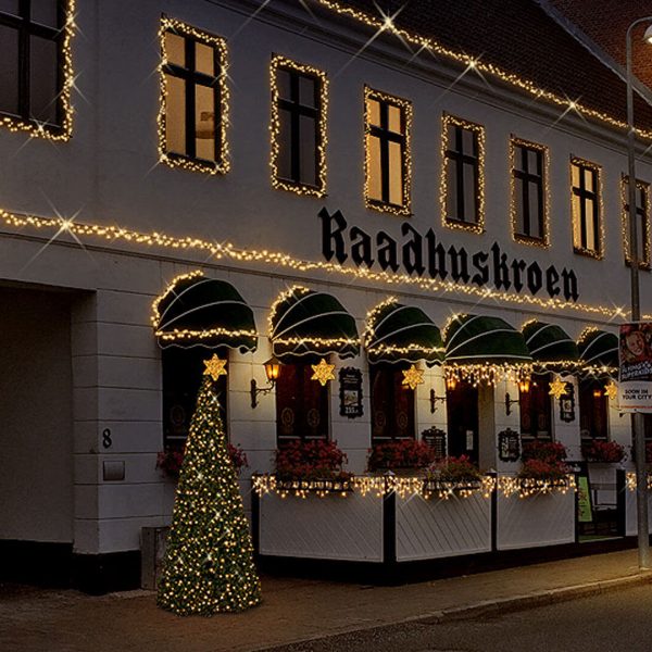 With lighting greenery decorated facade of the restaurant Rådhuskroen in the city of Ringsted, Denmark.