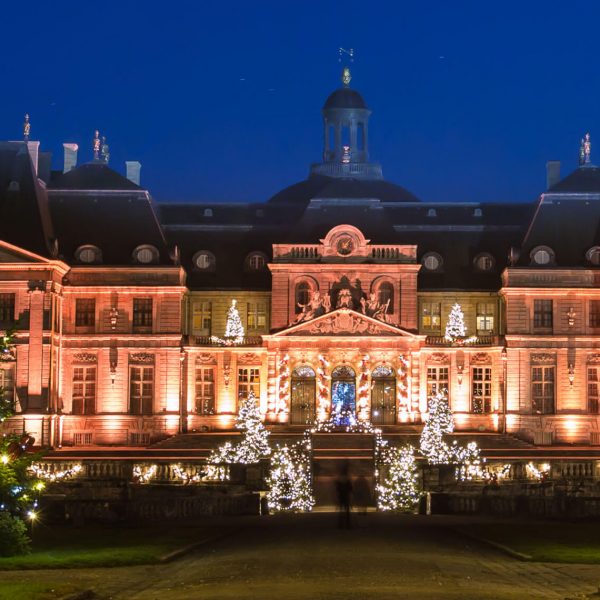 Illuminated christmas trees in front of the Château de Vaux-le-Vicomte in the city of Maincy, France.